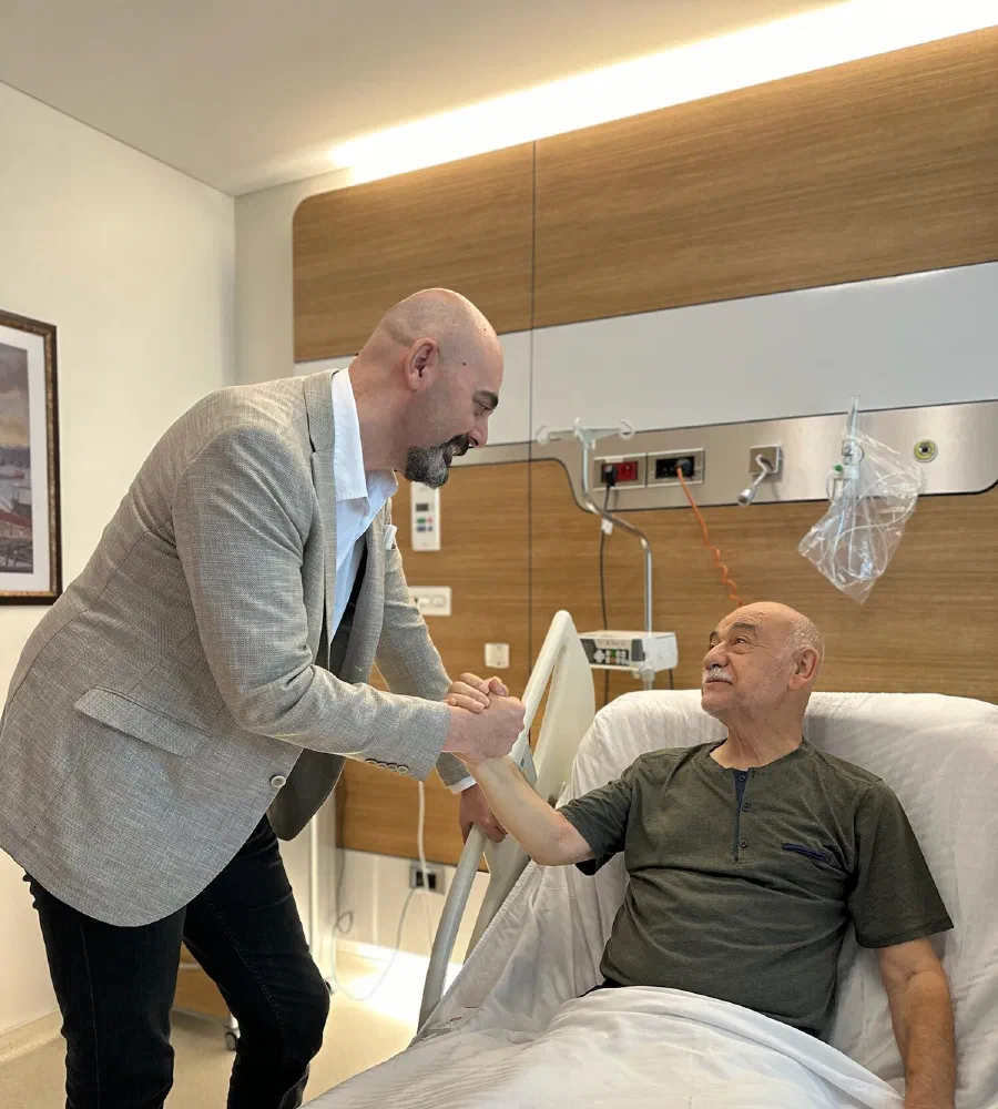 Prof. Dr. Aytaç Çetinkaya at a patient's bedside